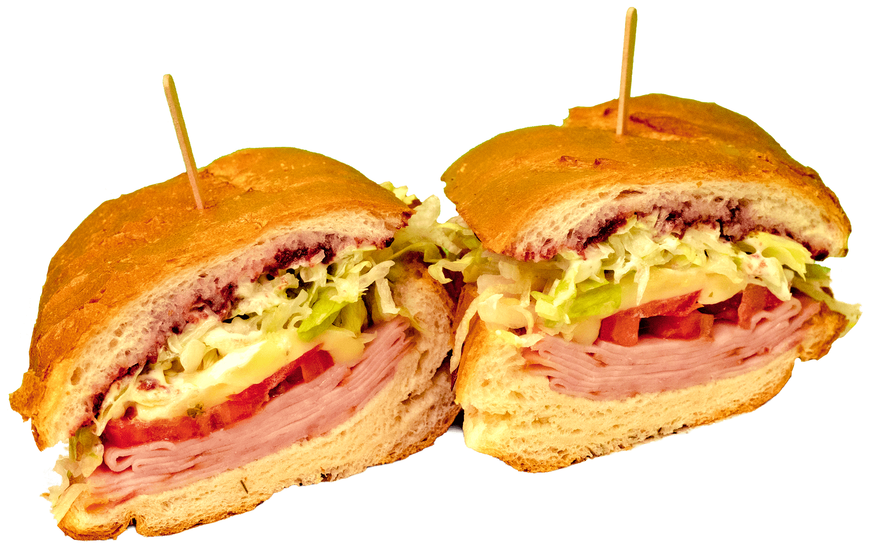A large deli sandwich, sliced in half, revealing layers of ham, cheese, tomatoes, shredded lettuce, and a dark red spread on a toasted sub roll, with a toothpick in each half.