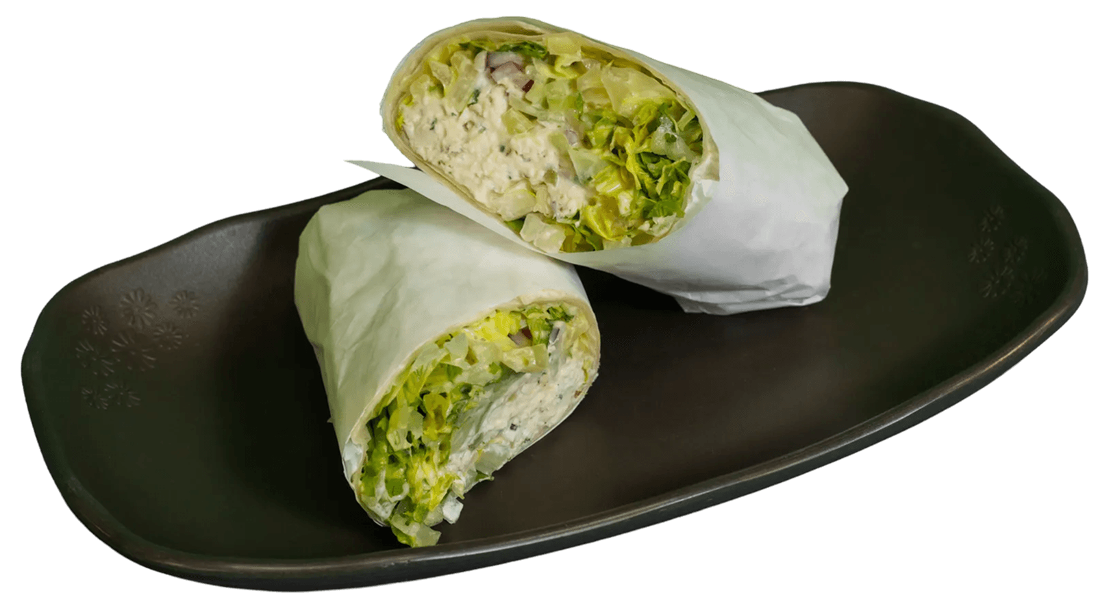 Two savory wraps, cut in half, revealing generous fillings of white meat, red cabbage, shredded carrots, creamy sauce, and fresh green herbs, topped with red spice.