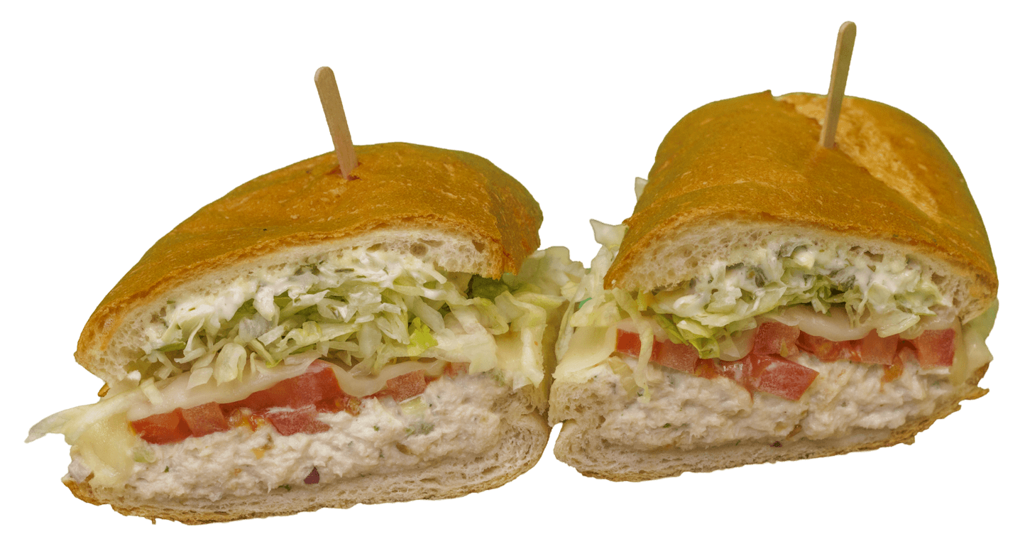 Tuna melt sub sandwich cut in half, displaying creamy tuna salad, diced tomatoes, shredded lettuce, and melted cheese on a toasted baguette, secured by wooden toothpicks.